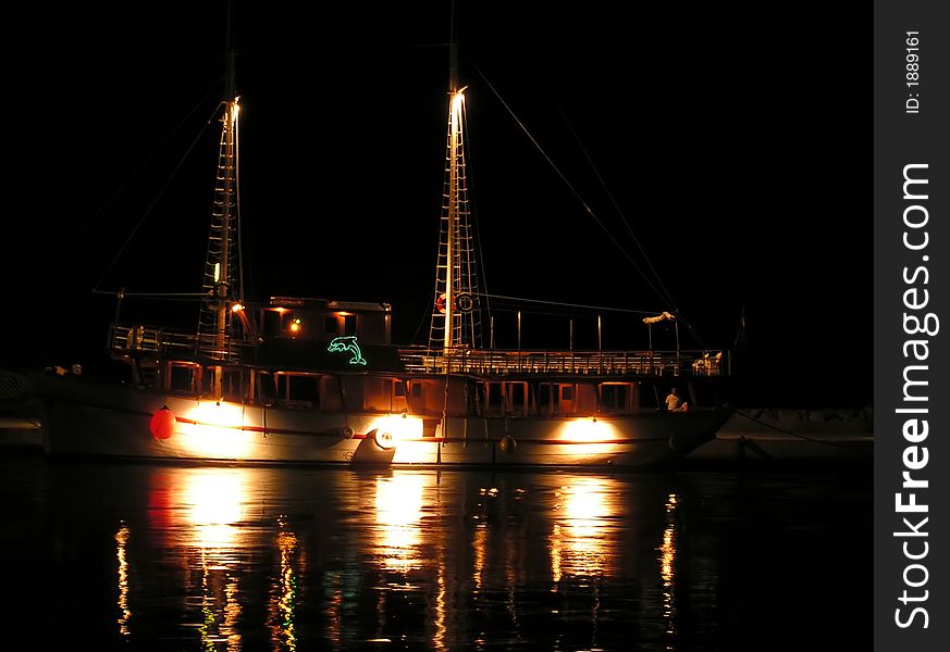 A old boat in the night with reflections.