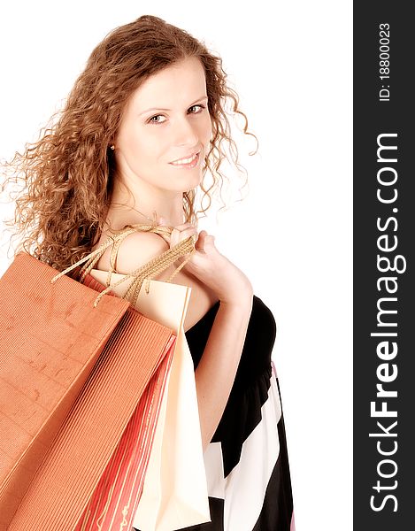Young woman carrying shopping bags isolated on the white background. Young woman carrying shopping bags isolated on the white background