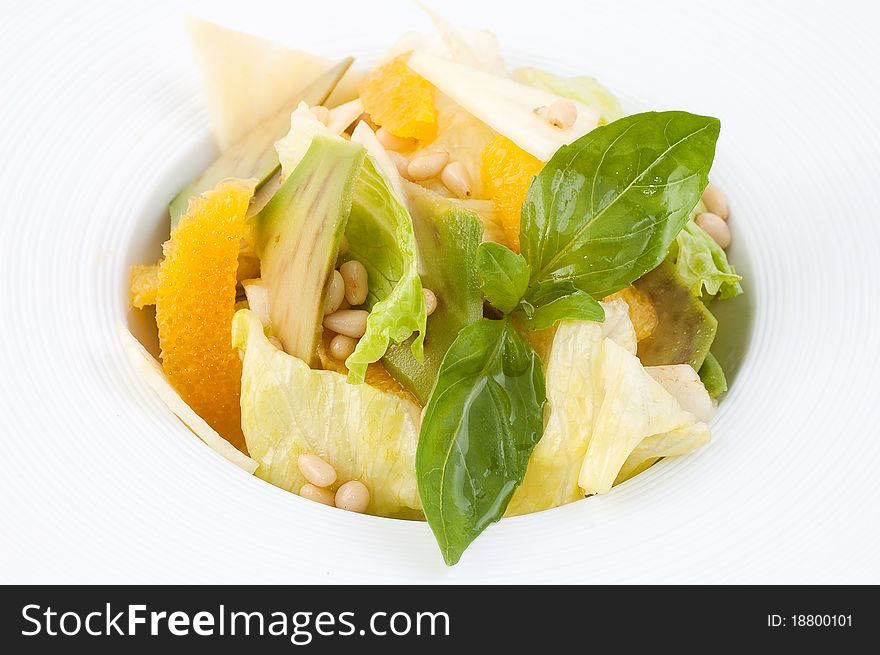 Salad from fresh vegetables close up on a white background