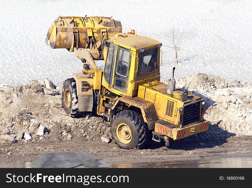 Process of cleaning of road from snow a heavy loader. Process of cleaning of road from snow a heavy loader