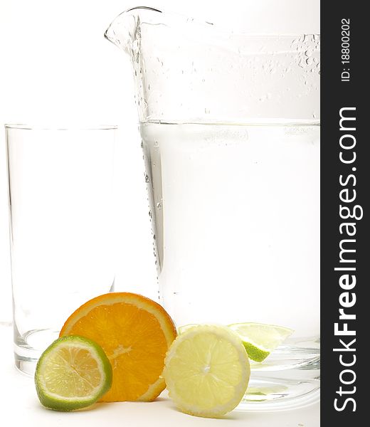 Lemon, Lime And Orange With A Jug And A Glass