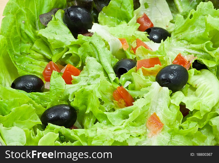 Greek salad style in plate on wood background