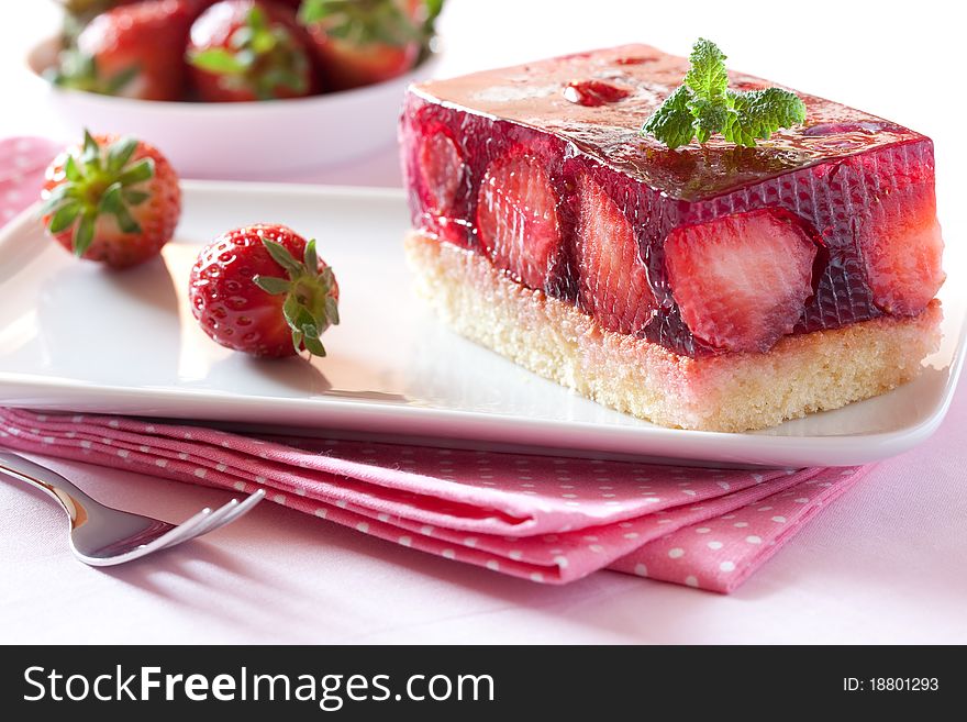 Fresh strawberry cake with mint leaf on plate