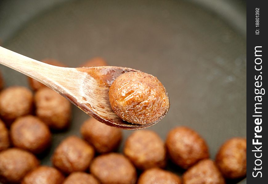Soy meat balls in a pan and a wooden spoon. Soy meat balls in a pan and a wooden spoon