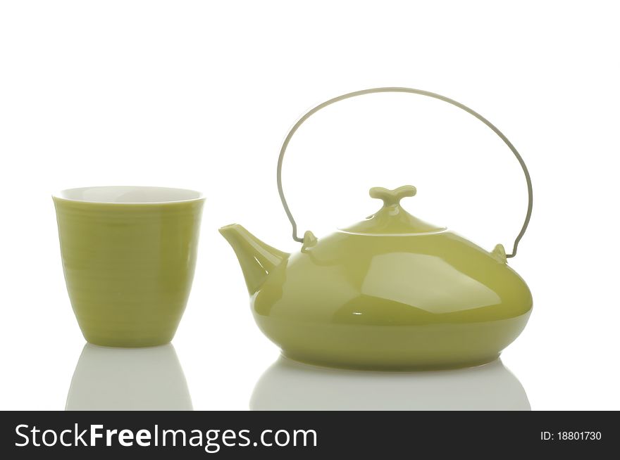 Teapot with tea and cup, isolated on a white background. Teapot with tea and cup, isolated on a white background.