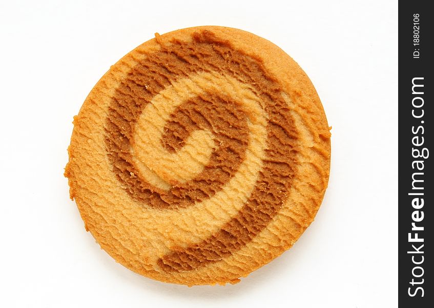 A single round baked light golden brown cookie. A single round baked light golden brown cookie.