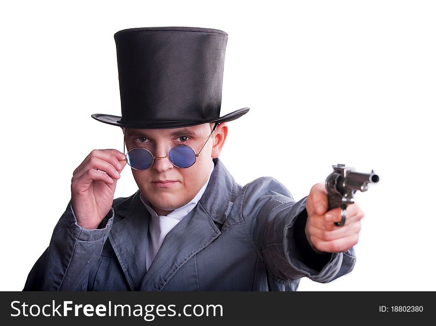 Portrait of the handsome man in a top-hat with a pistol in hand