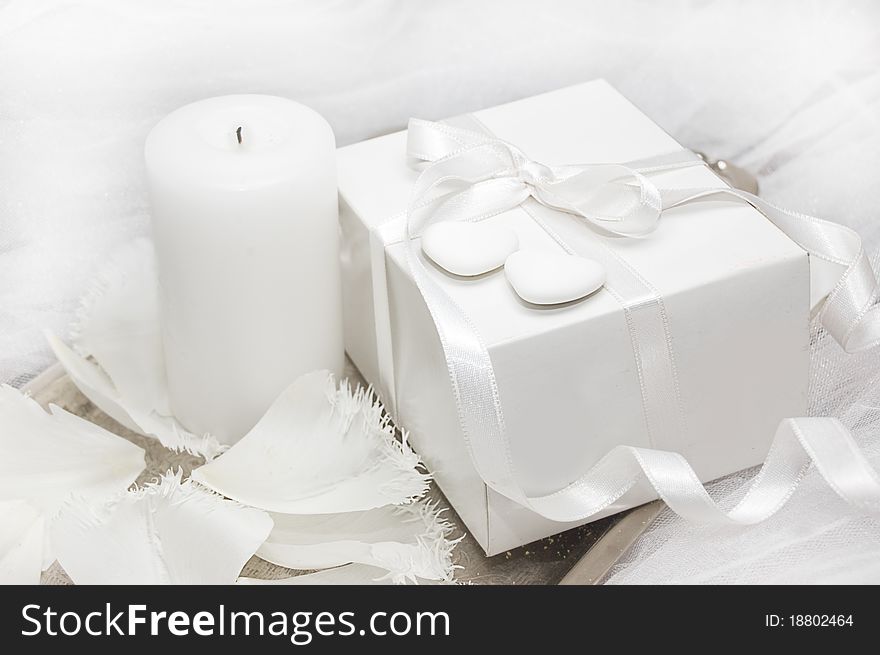 White gift box with candle and tulip