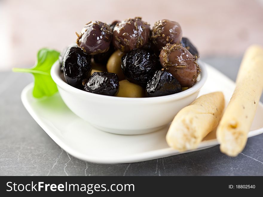 Marinated olives with herbs and grissini. Marinated olives with herbs and grissini