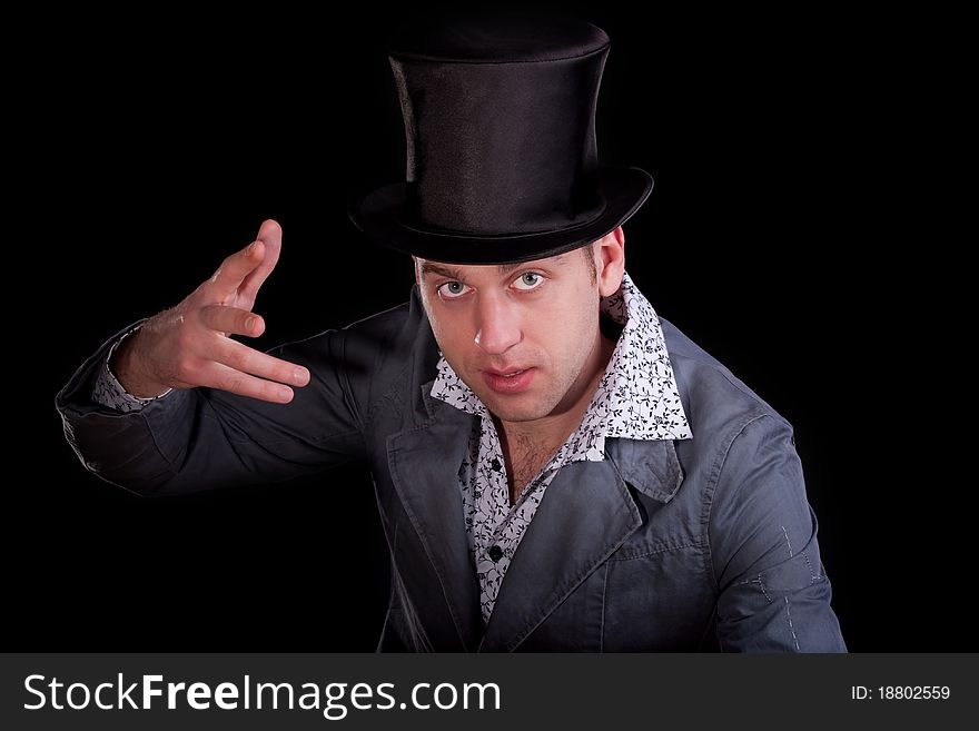 Emotional portrait of the young man in a black top-hat. Emotional portrait of the young man in a black top-hat