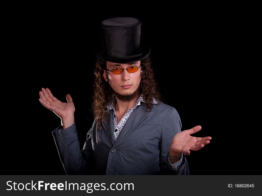 Portrait of the young serious man in a black top-hat