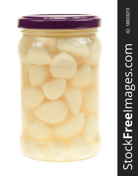 A jar of garlic pieces isolated on a white background