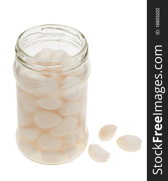 A jar of garlic pieces isolated on a white background