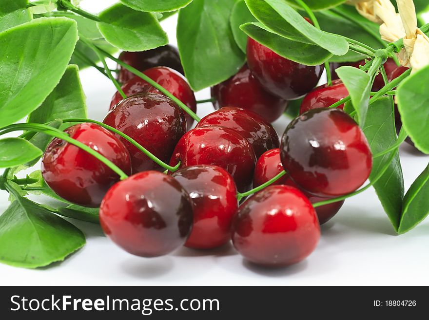 Sweet red cherries with leaves isolated on white background. Sweet red cherries with leaves isolated on white background