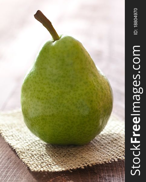 Fresh ripe pear on wooden table