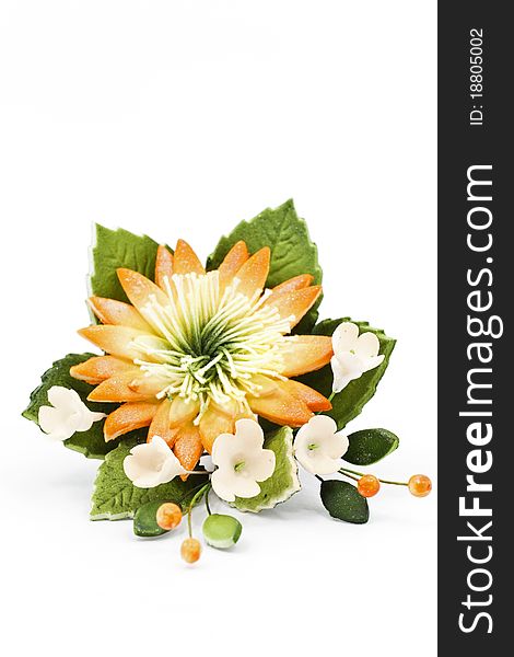 Multicolored candle arranged with beautiful flowers as a home and spa decoration. Multicolored candle arranged with beautiful flowers as a home and spa decoration