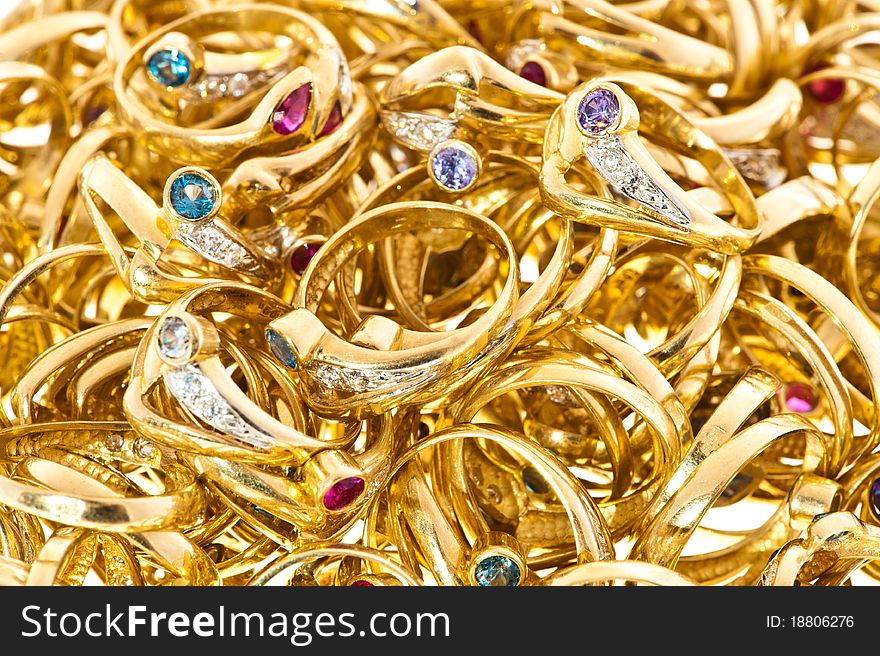 Lots of golden rings with different jewels. Lots of golden rings with different jewels