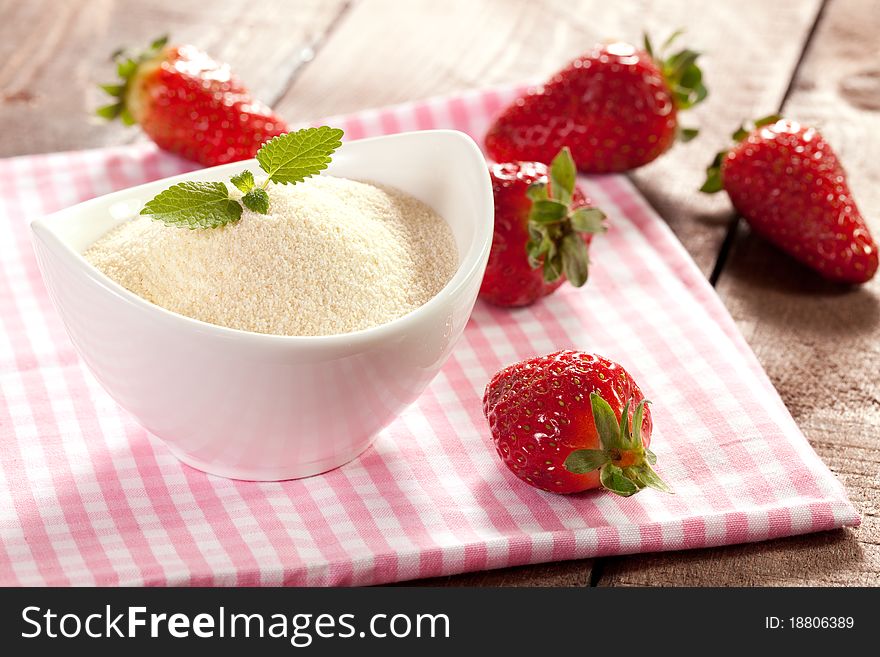 Semolina in bowl and strawberries. Semolina in bowl and strawberries