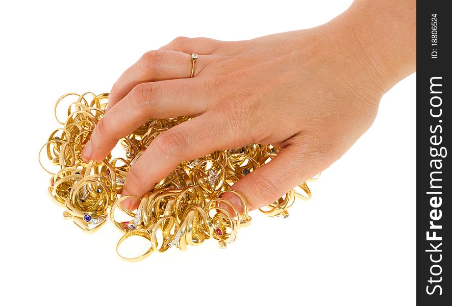 A woman's hand covering a bulk of rolden rings. A woman's hand covering a bulk of rolden rings