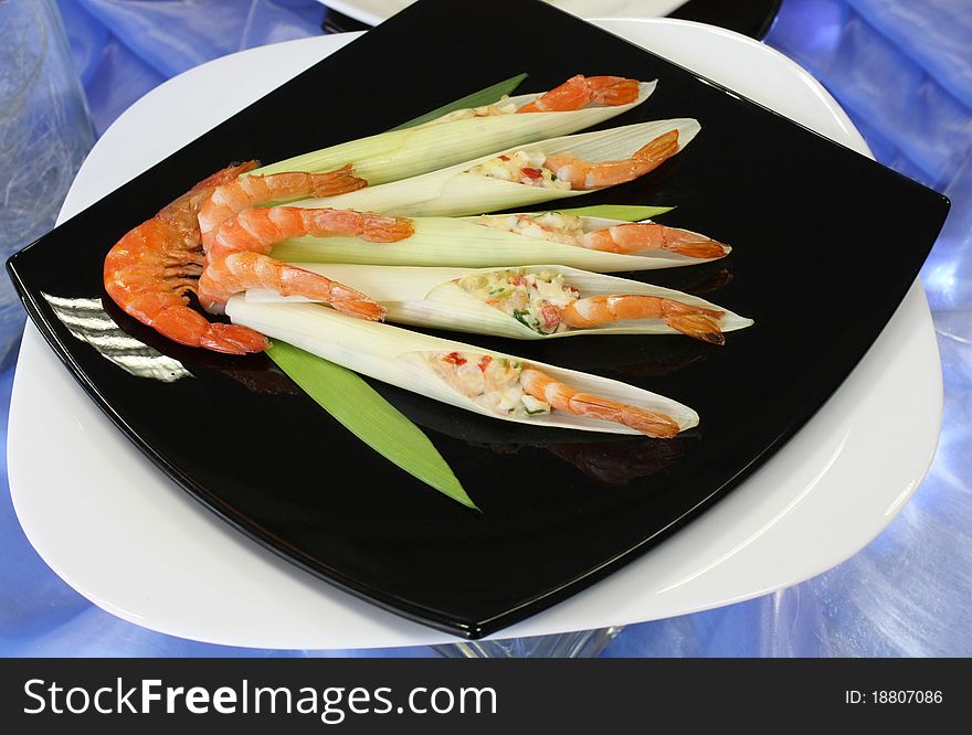 Cold appetizer of shrimp with vegetables on the plate