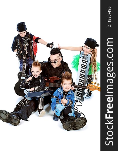 Heavy metal musician  with a group of stylish children. Shot in a studio. Isolated over white background. Heavy metal musician  with a group of stylish children. Shot in a studio. Isolated over white background.