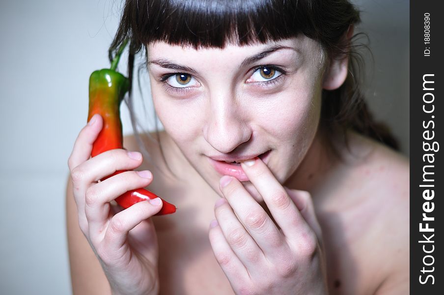 Woman holding hot peeper as a phone. Conceptual hot line. Woman holding hot peeper as a phone. Conceptual hot line