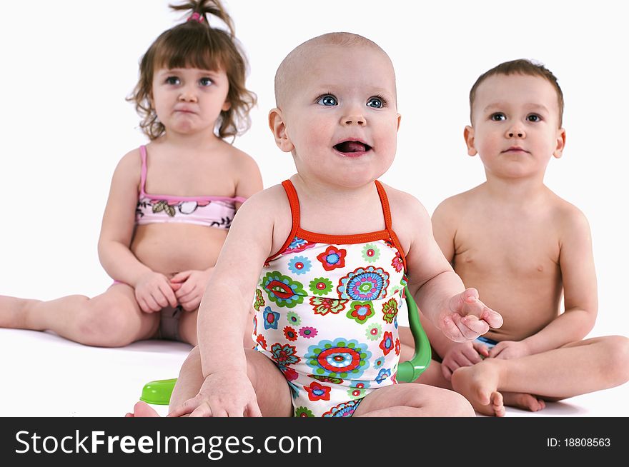 Three small children in swimsuit