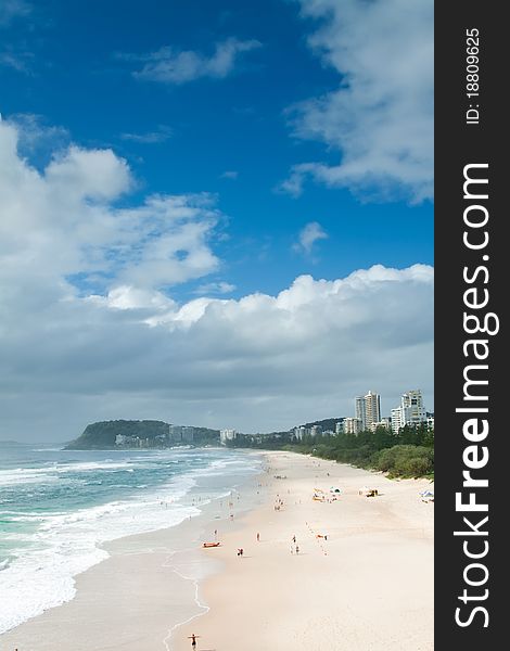 Australian beach during the day with clouds in background on vertical format (burleigh heads,qld,australia)