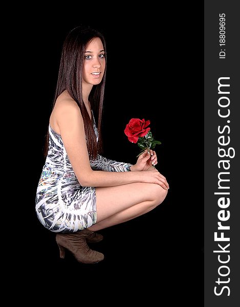 A beautiful young woman in a short tight dress, hocking on the floor
in profile in the studio with a rose in her hand, for black background. A beautiful young woman in a short tight dress, hocking on the floor
in profile in the studio with a rose in her hand, for black background.