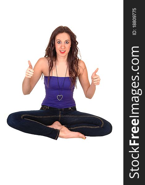 A pretty young woman in jeans and a strap less top sitting on the floor with booths her thumbs up for white background. A pretty young woman in jeans and a strap less top sitting on the floor with booths her thumbs up for white background.