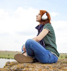 Girl With Headphones At Rock Near Lake. Stock Photo Girl With Headphones At Rock Near Lake. Stock Photo