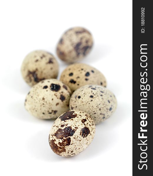 Quail eggs isolated against a white background