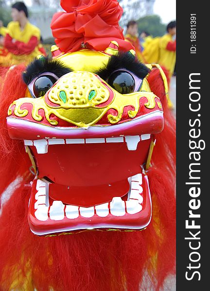 People playing lion dances to celebrate festivals during chinese new year,lion dances during festivals are part of the traditional custom in China.