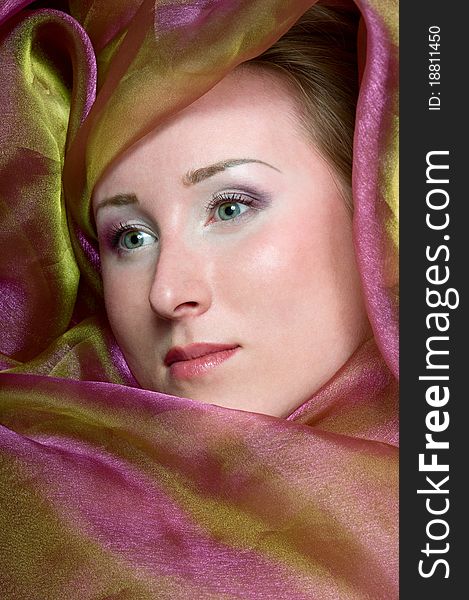 Vogue portrait of a women covered in violet fabrics. Vogue portrait of a women covered in violet fabrics