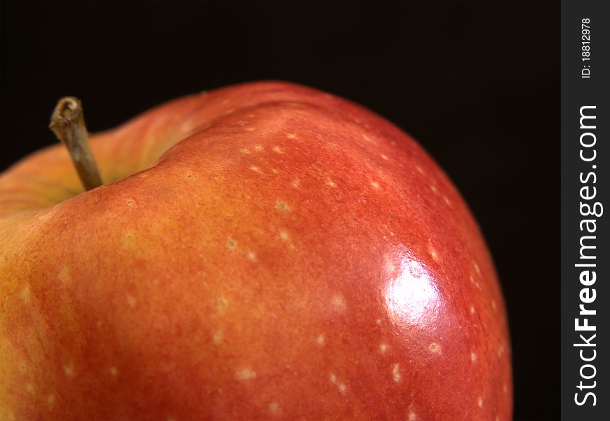 Tasty red apple on dark background