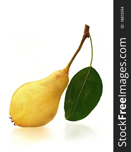 Tasty fresh pear with leaf on bright mirroring background. Tasty fresh pear with leaf on bright mirroring background