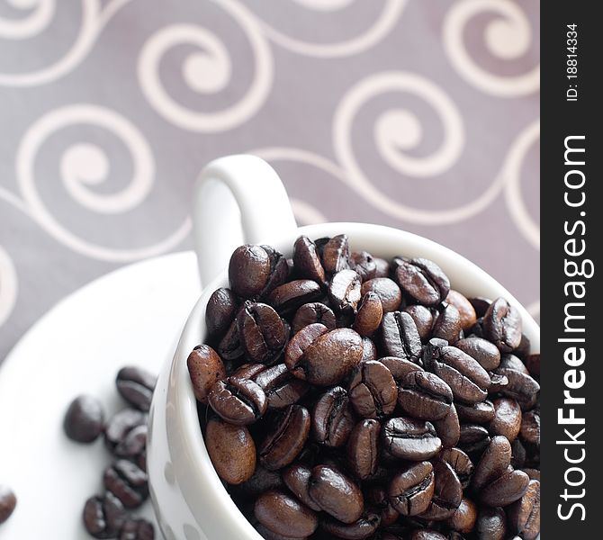 Coffeebeans in coffee cup on dark background. Coffeebeans in coffee cup on dark background