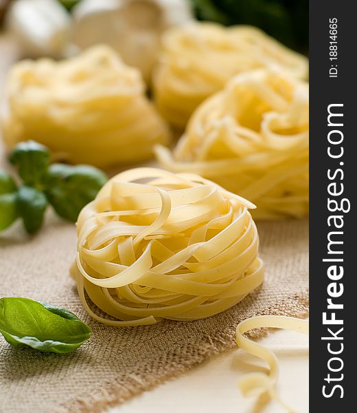Pasta ingredients; fresh tagliatelle, garlic,basil Selective focus