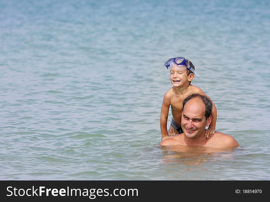 Father and son playing in water. Father and son playing in water