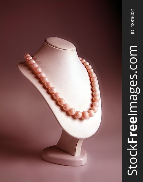 Pink coral necklace on display. Pink coral necklace on display
