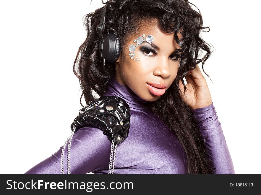 Mulatto girl DJ listens music with headphones