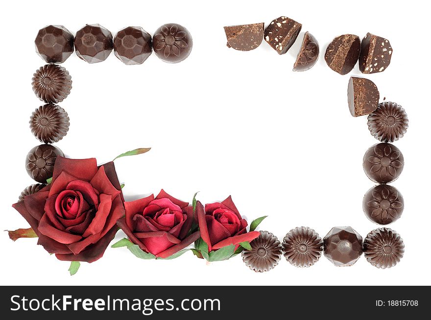 Beautiful red rose and chocolate frame on white background