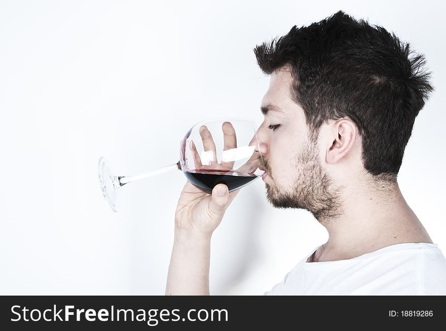 ısolated image of a young man drinking a glass of red wine. ısolated image of a young man drinking a glass of red wine