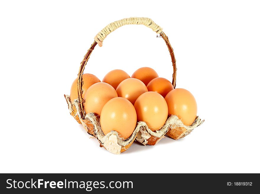 Chicken eggs in a basket made of natural materials, isolated