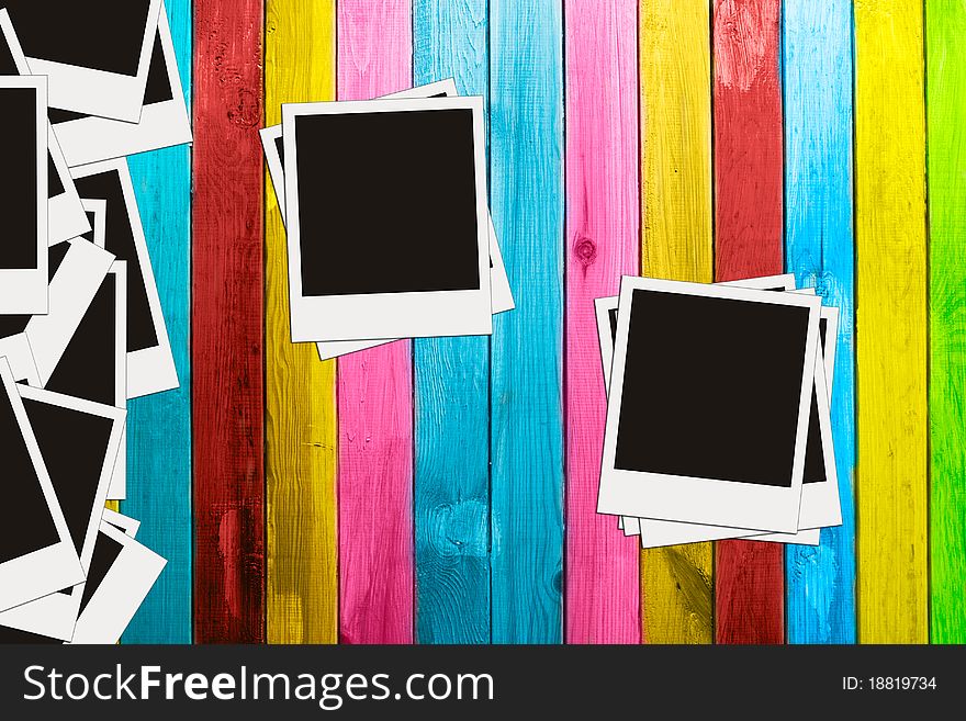 Blank photos on vintage multicolored wooden background