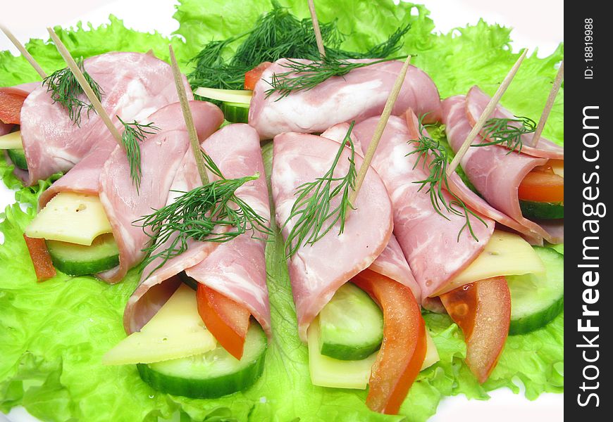 Bacon meat rolls on lettuce vegetable isolated on white. Bacon meat rolls on lettuce vegetable isolated on white