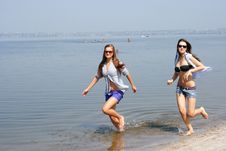 Happy Young Women Running Across The Beach Royalty Free Stock Photos