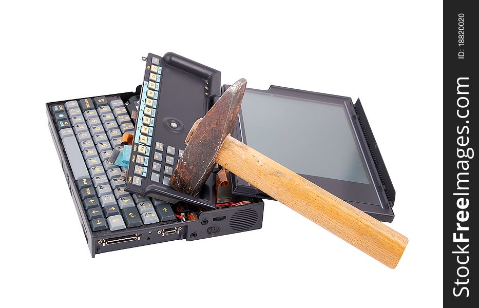 Old crashed notebook and hammer