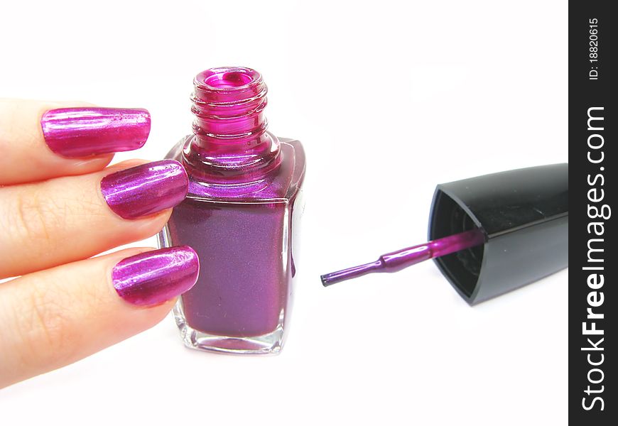 Violet nail polisher doing manicure on hand isolated on white