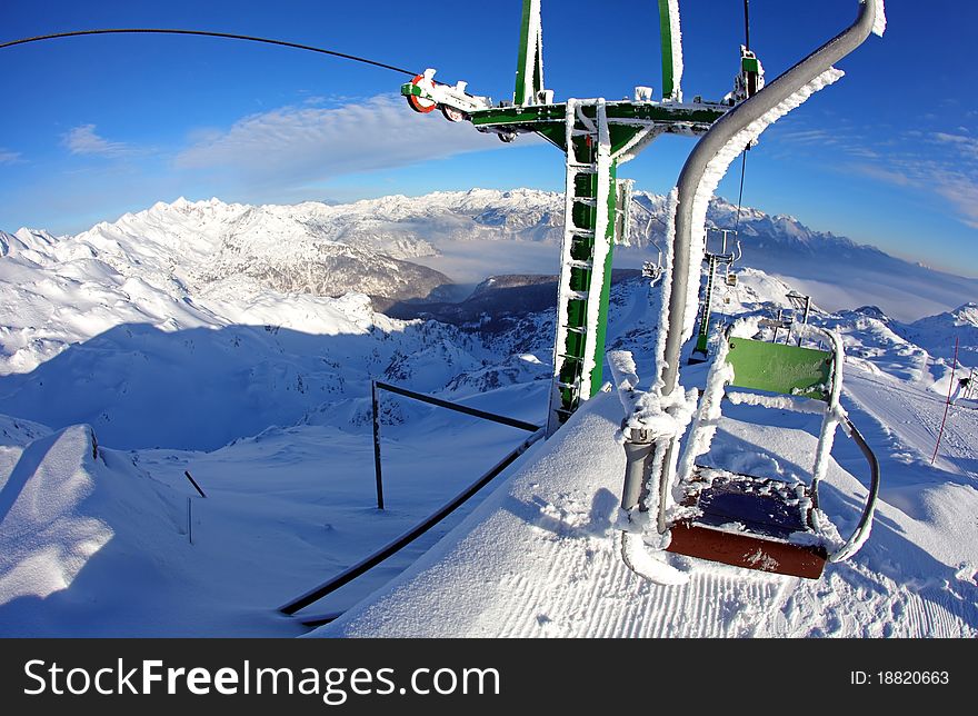 Chairlift in the ski resort, wintertime mountain landscape